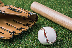 Close Up View Of Baseball Equipment Arranged On Green Grass Close Up View Of Baseball Equipment Arranged On Green Grass